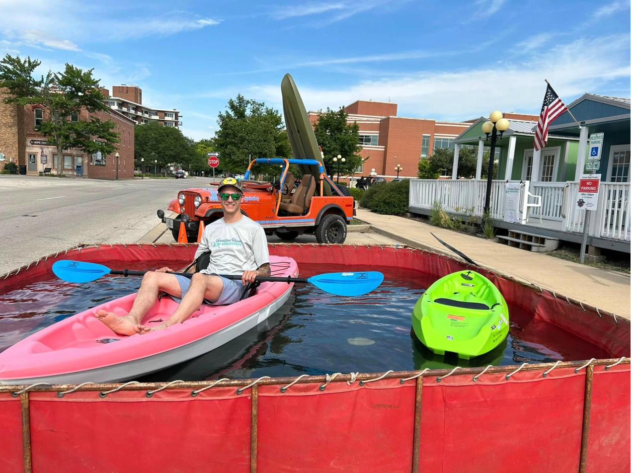Community members trying kayaks at a Pontiac, Illinois event